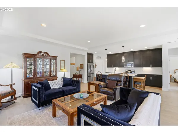 a living room with furniture kitchen view and a fireplace