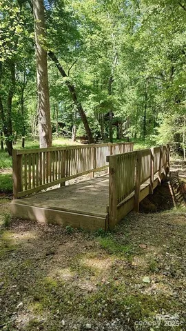 a view of a garden with wooden bench