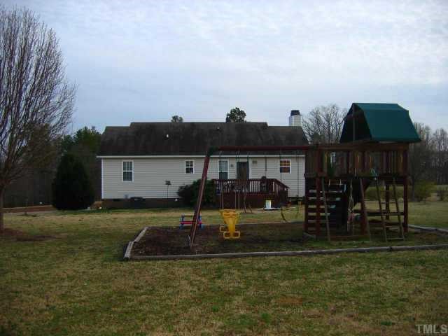 8099 Covered Bridge Road Wendell, NC 27591 - Photo 11 of 12 Entertaining deck off rear of home - located on a nice corner lot.New HVAC in 2006