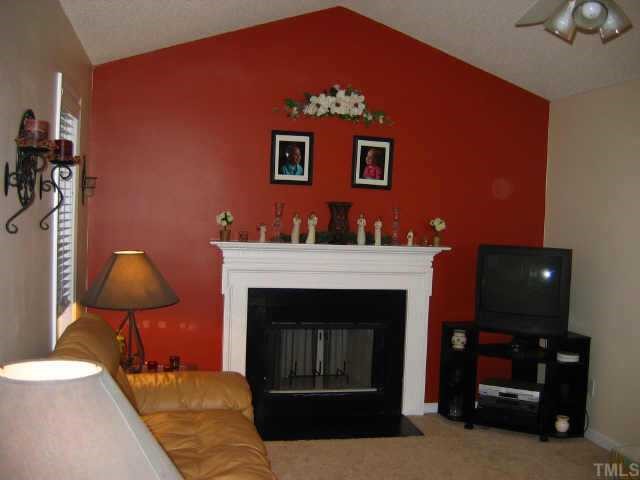 Vaulted ceiling living room w/fireplace and accent wall