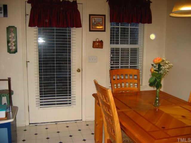 Bright dining area w/windows and door leading to deck.