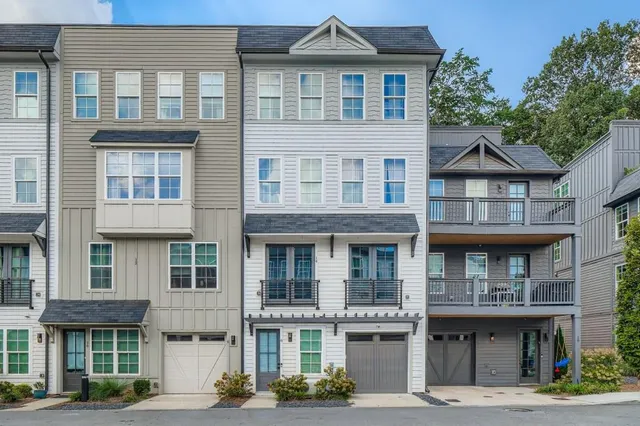 a front view of a residential apartment building with a yard