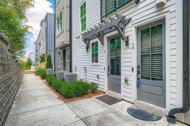 a view of a pathway along the path along with potted plants