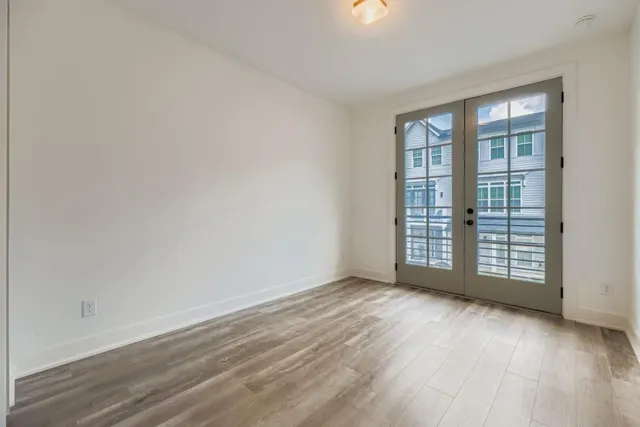 wooden floor in an empty room with a window