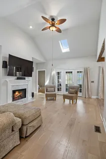 a large kitchen with stainless steel appliances granite countertop a stove and a wooden floors