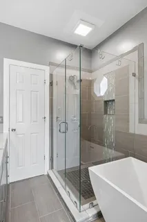 a bathroom with a granite countertop sink toilet a mirror and shower
