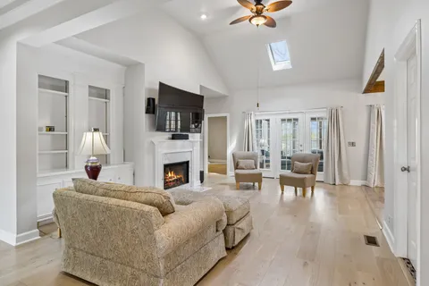 a living room with furniture a fireplace and a flat screen tv