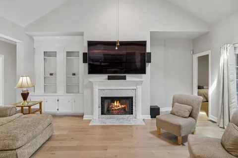 a living room with furniture and a fireplace