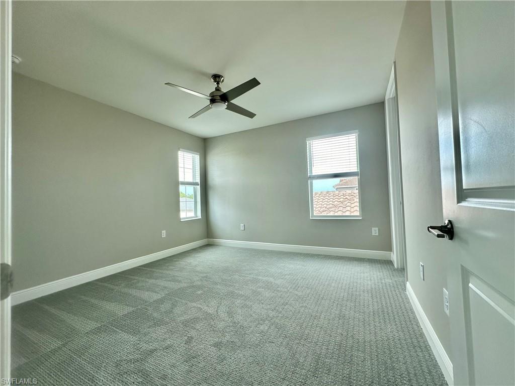 4580 Centaurus Circle Naples, FL 34120 - Photo 11 of 25 Carpeted spare room with plenty of natural light and ceiling fan