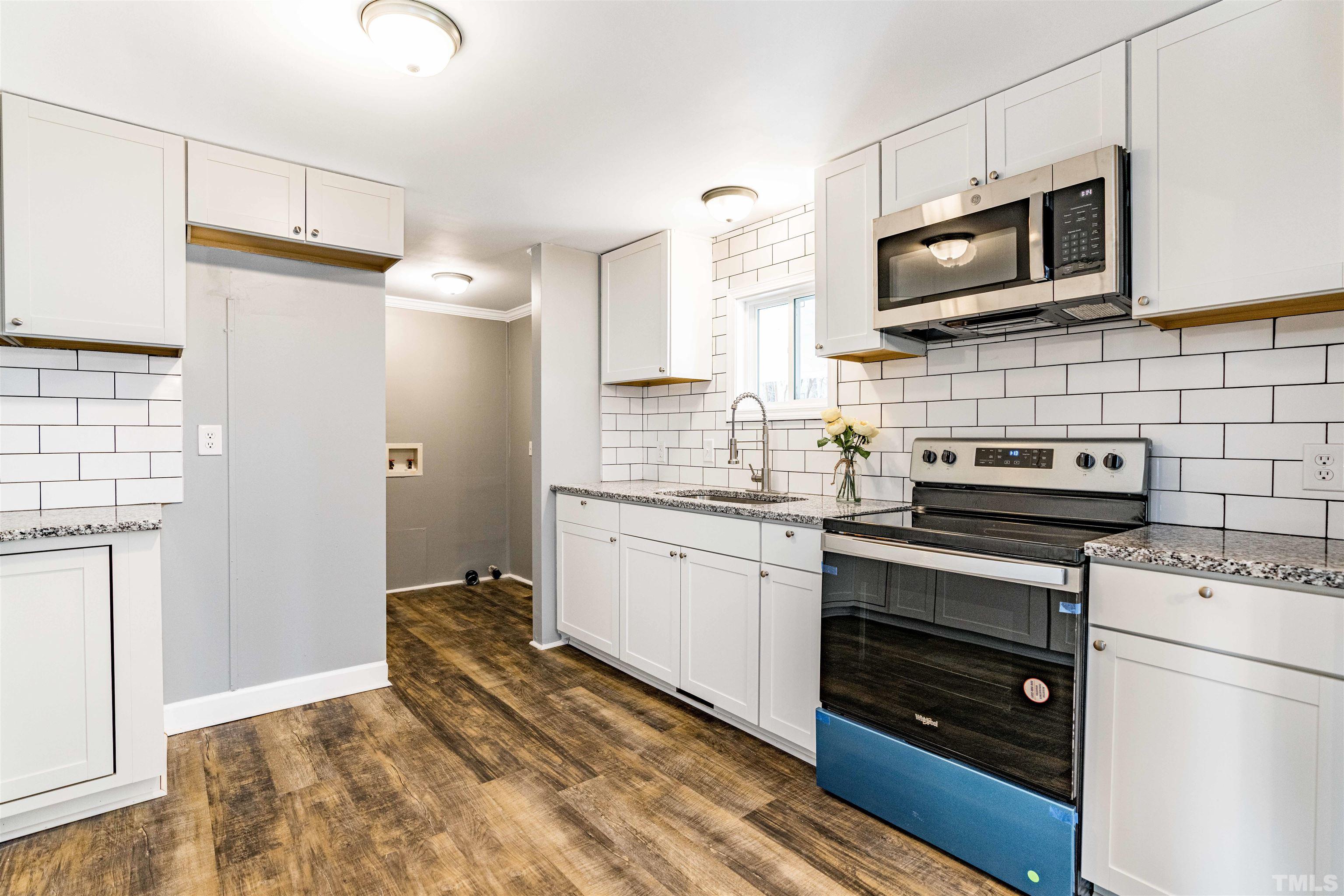 1100 Yakimas Road Raleigh, NC 27603 - Photo 11 of 26 a kitchen with a refrigerator stove and microwave