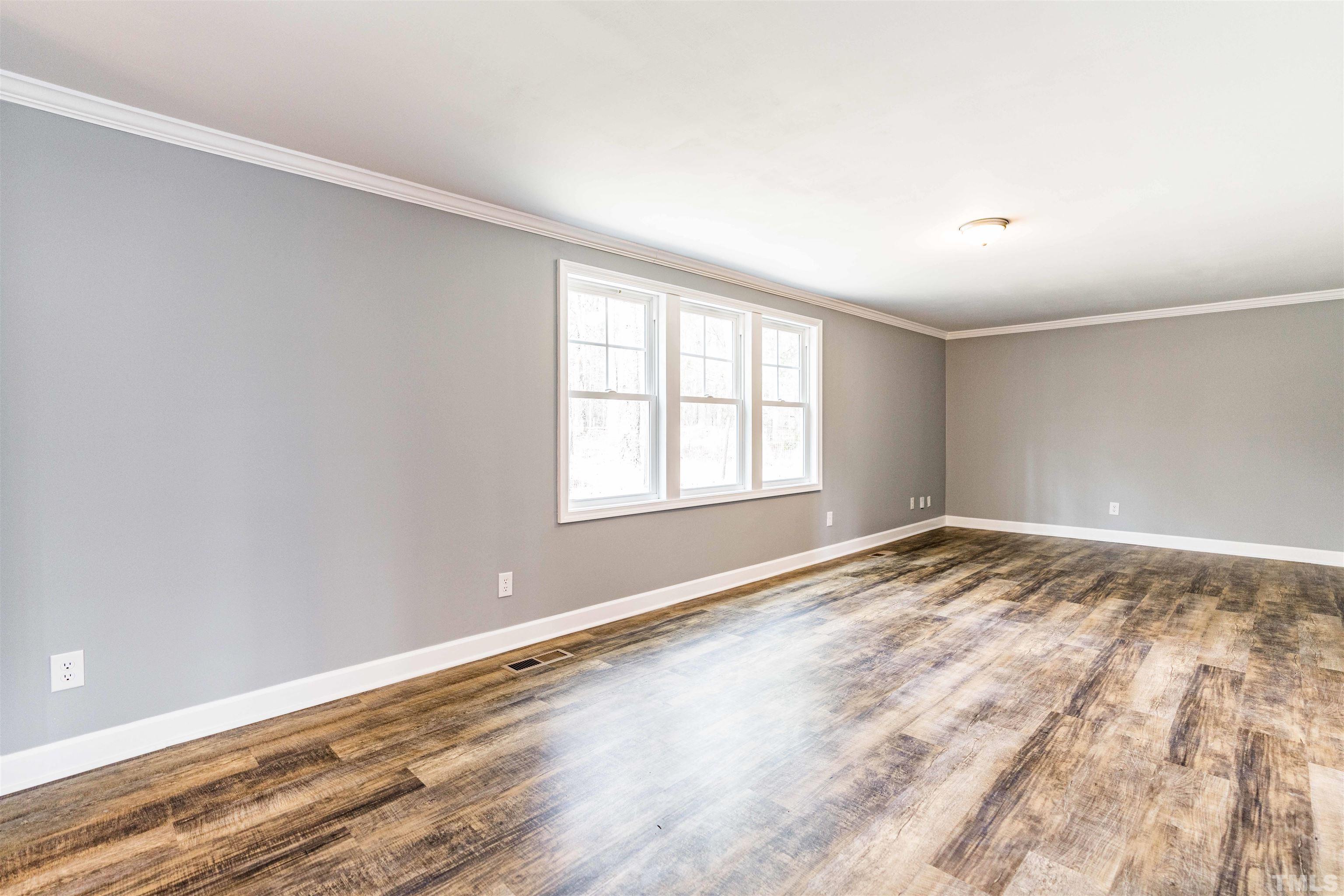 1100 Yakimas Road Raleigh, NC 27603 - Photo 16 of 26 wooden floor in an empty room with a window