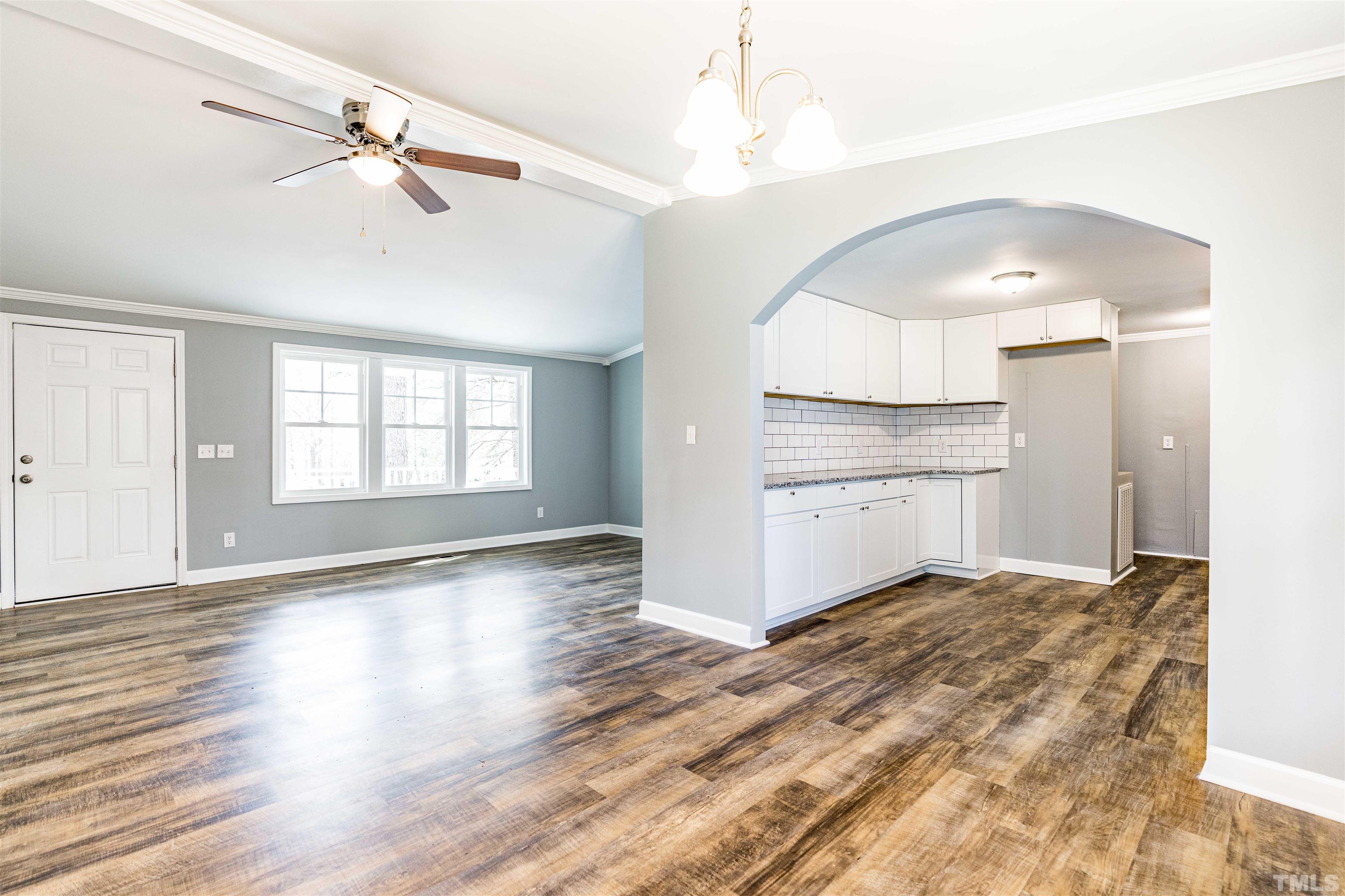 1100 Yakimas Road Raleigh, NC 27603 - Photo 17 of 26 a view of a kitchen with wooden floor and a ceiling fan