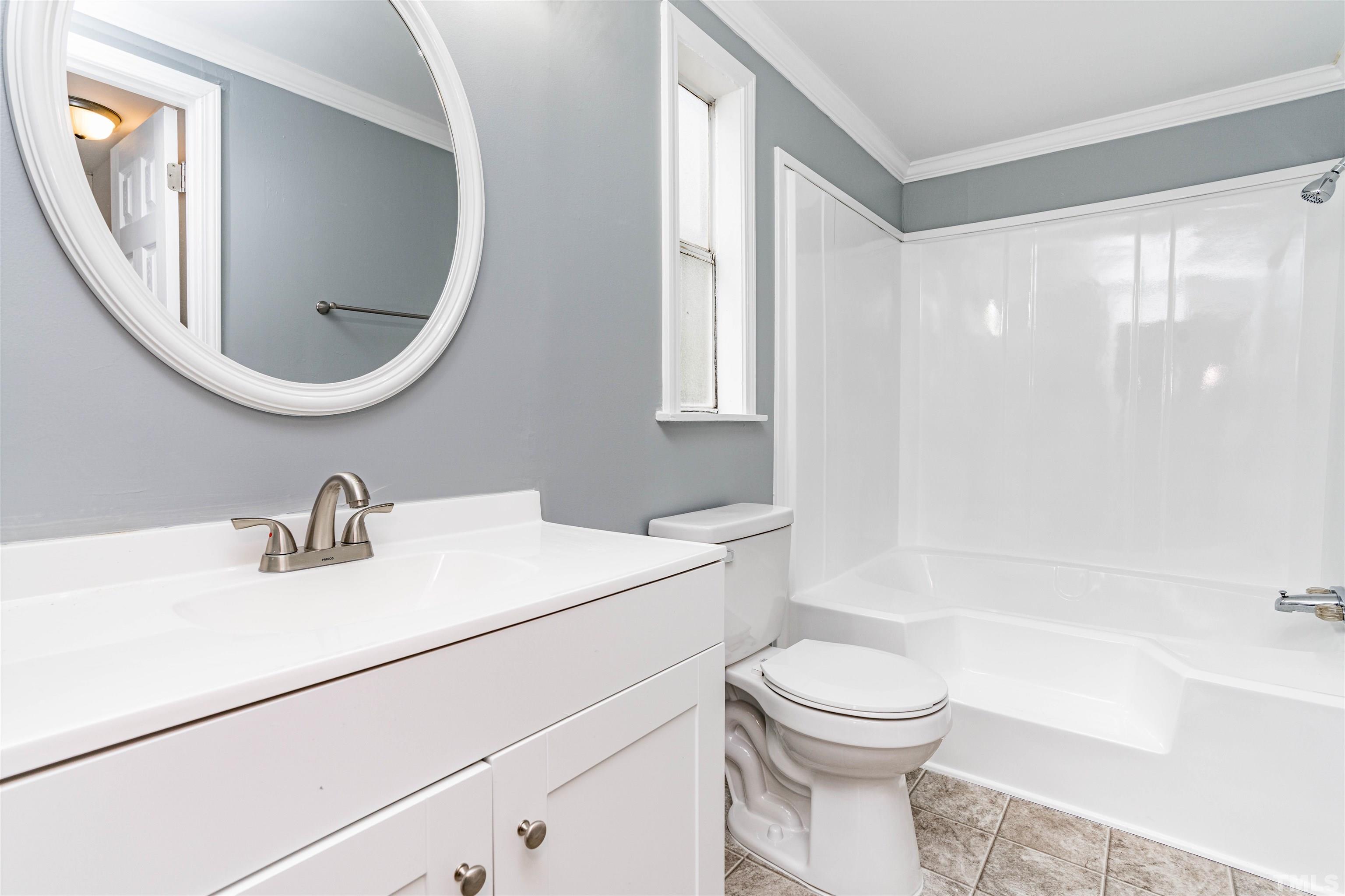 1100 Yakimas Road Raleigh, NC 27603 - Photo 19 of 26 a bathroom with a sink a toilet and a mirror