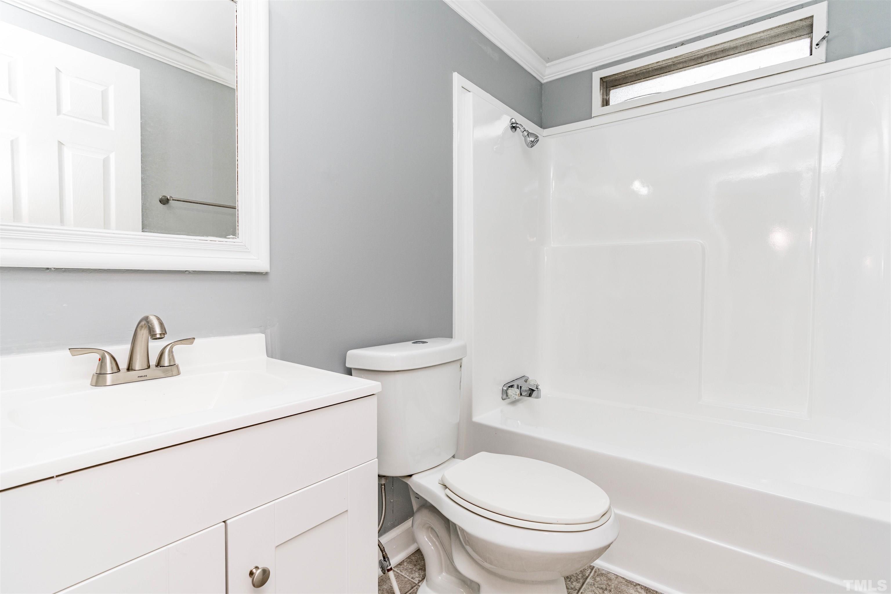 1100 Yakimas Road Raleigh, NC 27603 - Photo 23 of 26 a white toilet sitting next to a bathroom sink