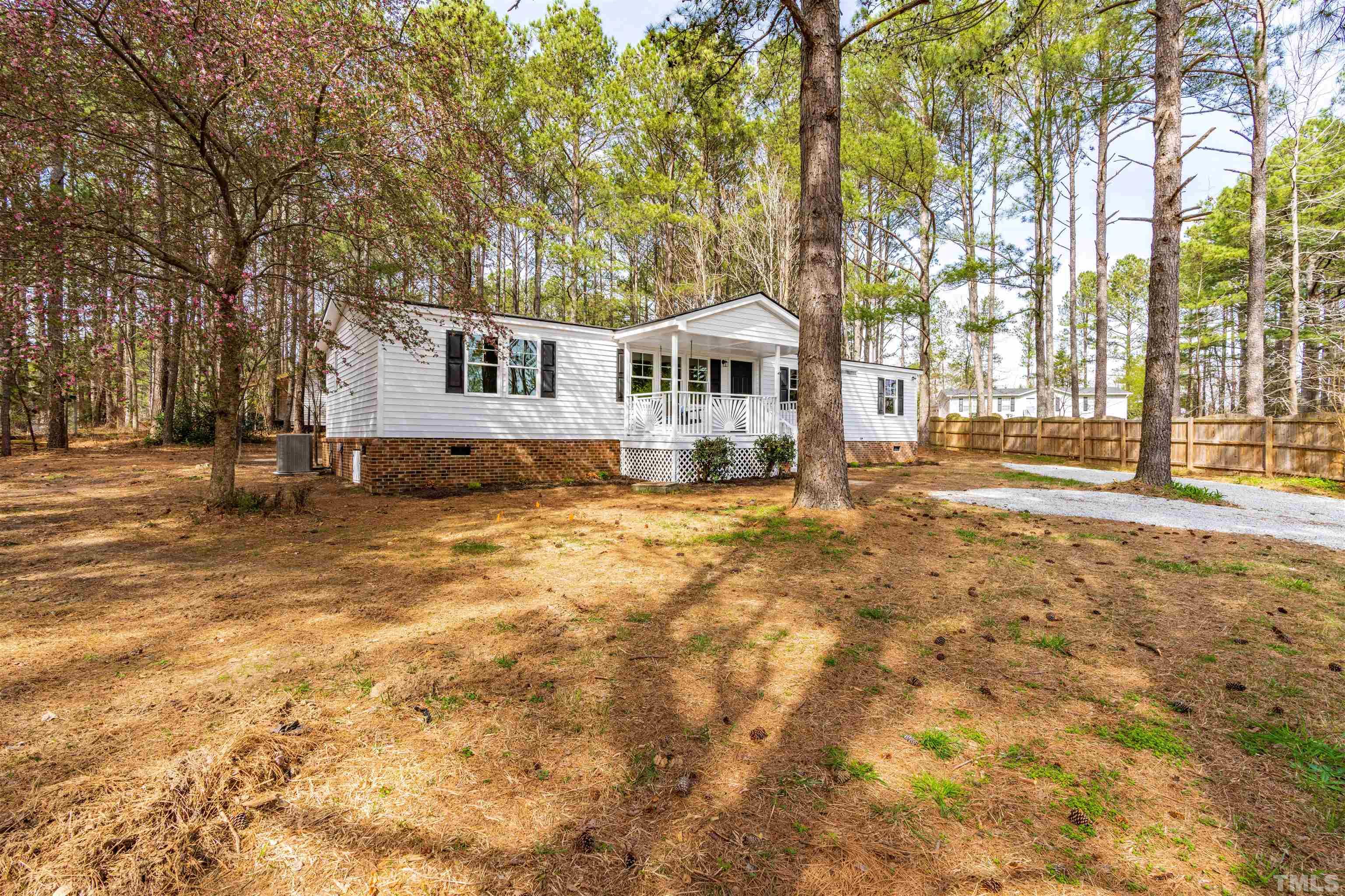 1100 Yakimas Road Raleigh, NC 27603 - Photo 3 of 26 a front view of a house with a yard and large trees