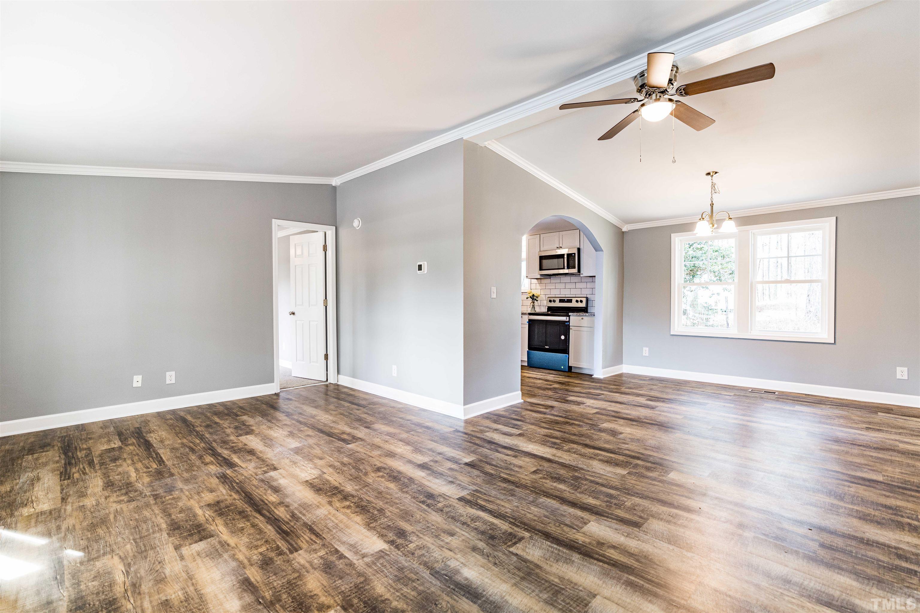 1100 Yakimas Road Raleigh, NC 27603 - Photo 6 of 26 a view of an empty room with a window and a ceiling fan