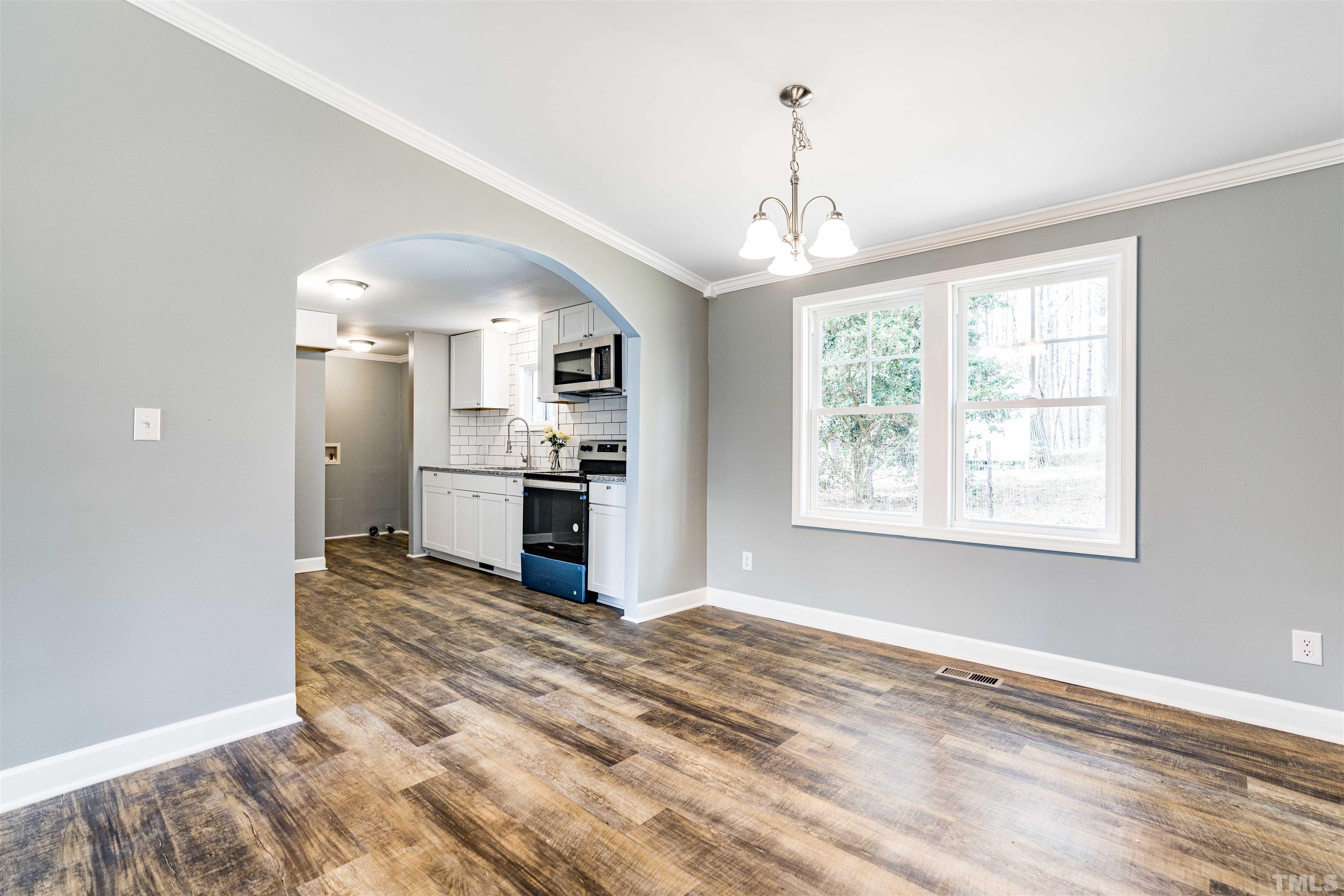 1100 Yakimas Road Raleigh, NC 27603 - Photo 7 of 26 a view of a kitchen with a stove cabinets and a large window