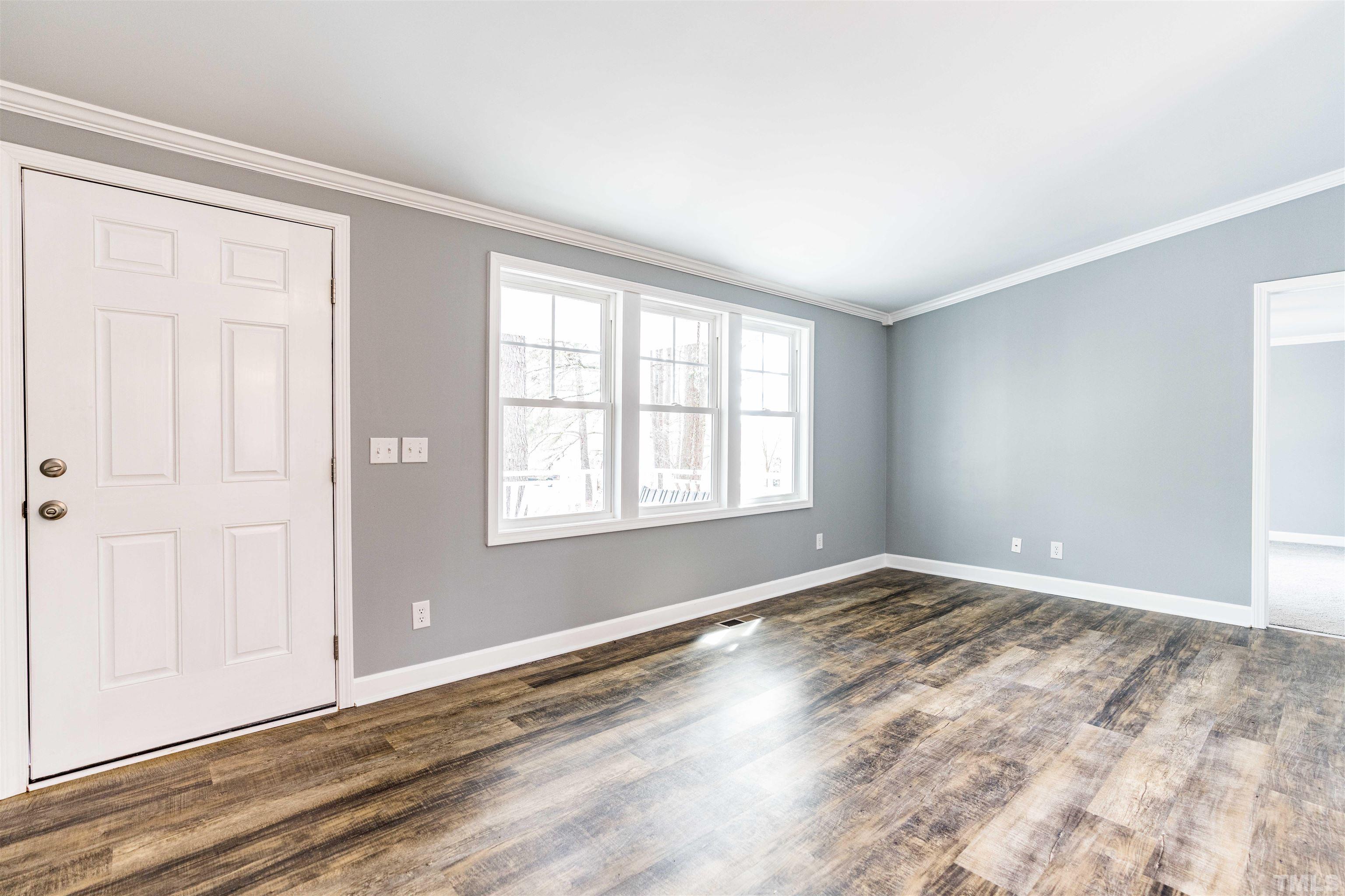 1100 Yakimas Road Raleigh, NC 27603 - Photo 8 of 26 a view of an empty room with wooden floor and a window
