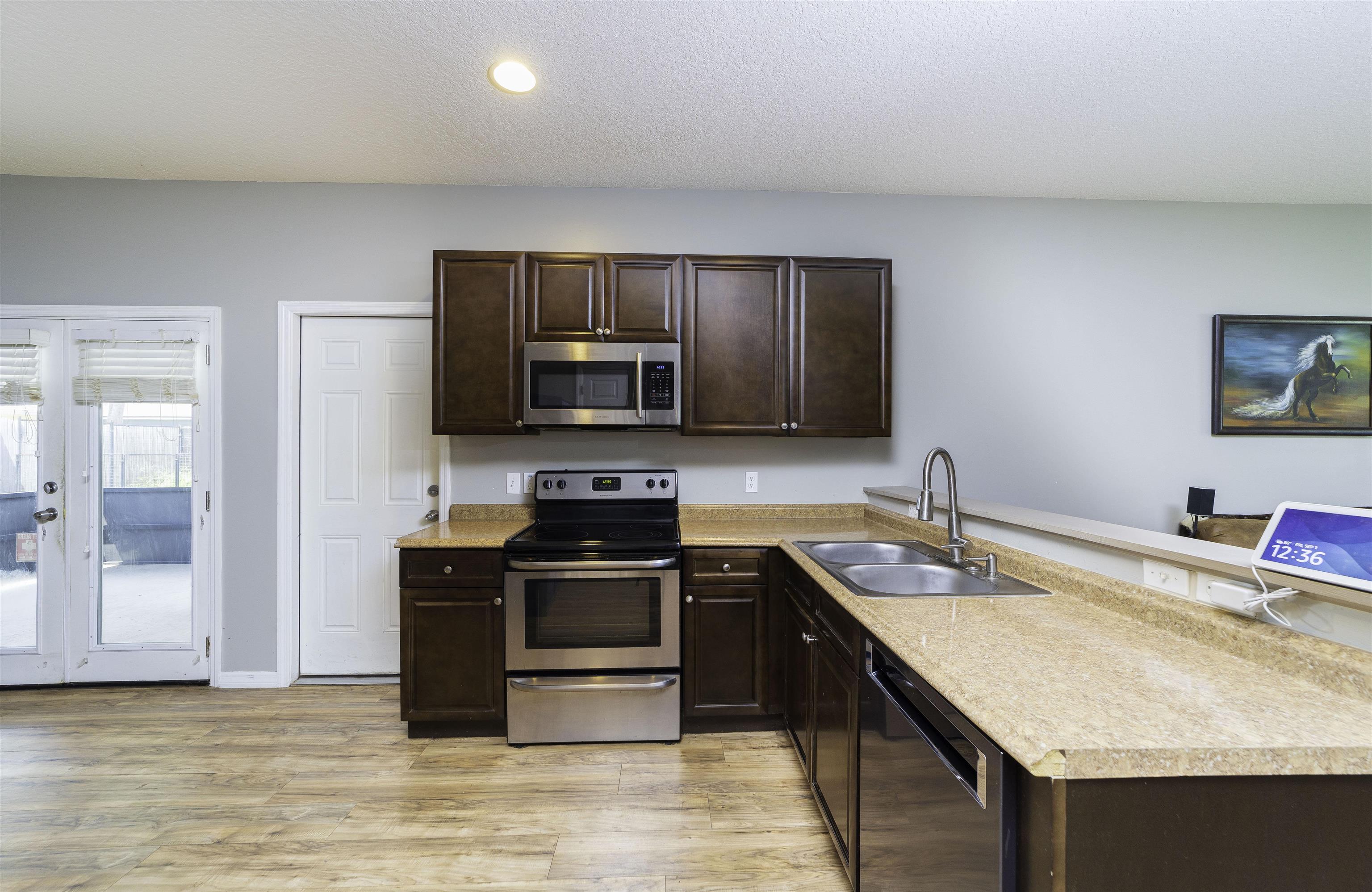 122 Osprey Road St. Augustine, FL 32086 - Photo 13 of 50 a kitchen with stainless steel appliances granite countertop a sink stove microwave and refrigerator