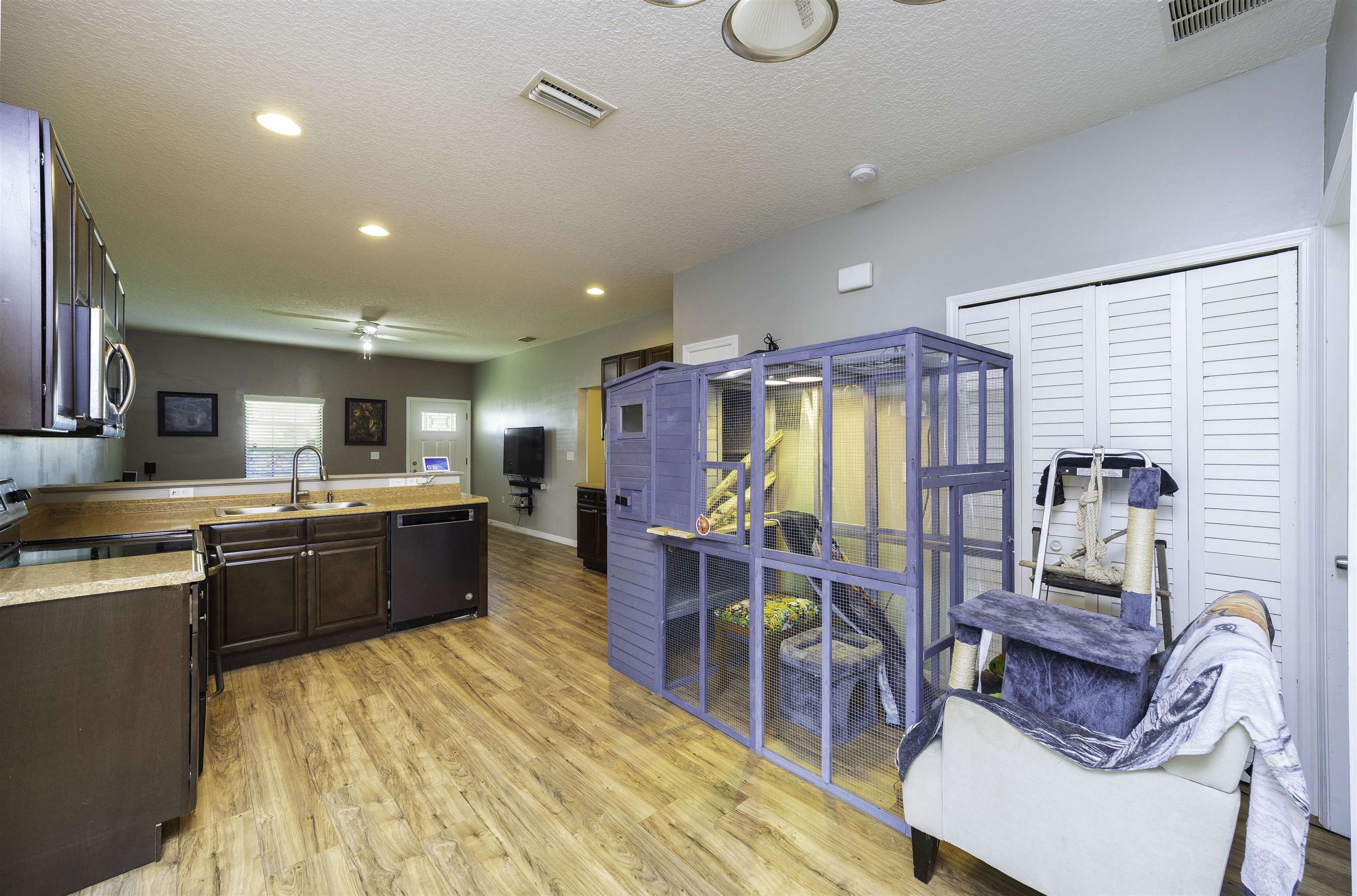 122 Osprey Road St. Augustine, FL 32086 - Photo 18 of 50 a large kitchen with stainless steel appliances kitchen island granite countertop a table chairs in it and a wooden floors