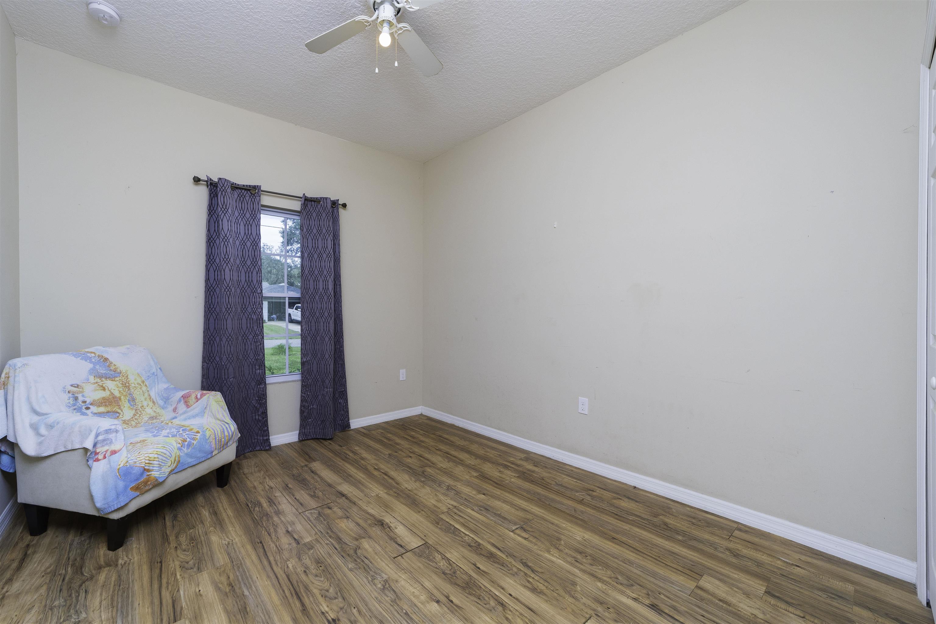 122 Osprey Road St. Augustine, FL 32086 - Photo 25 of 50 a bedroom with a bed and wooden floor