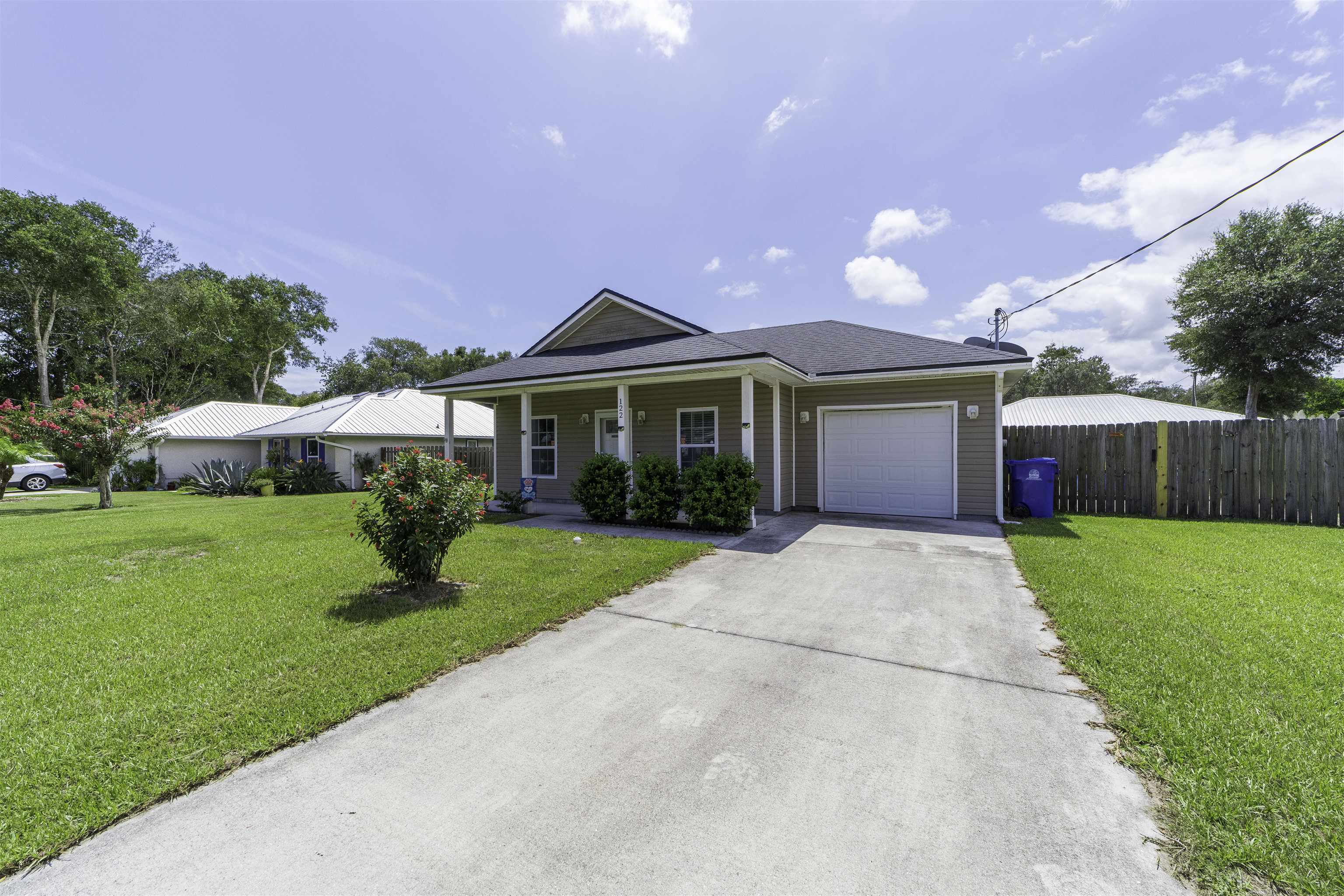 122 Osprey Road St. Augustine, FL 32086 - Photo 3 of 50 a front view of a house with a garden and yard