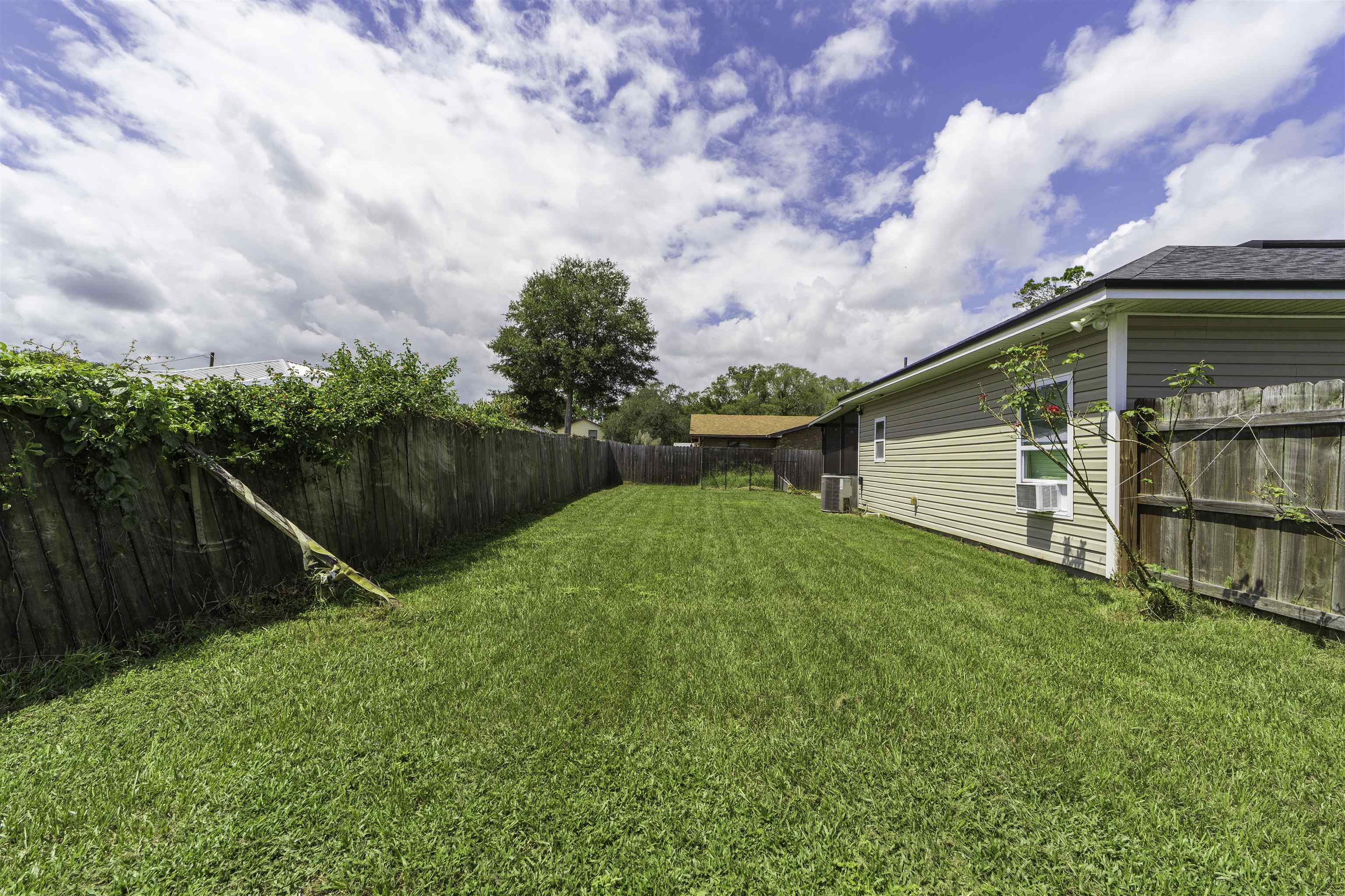 122 Osprey Road St. Augustine, FL 32086 - Photo 44 of 50 a backyard of a house with lots of green space
