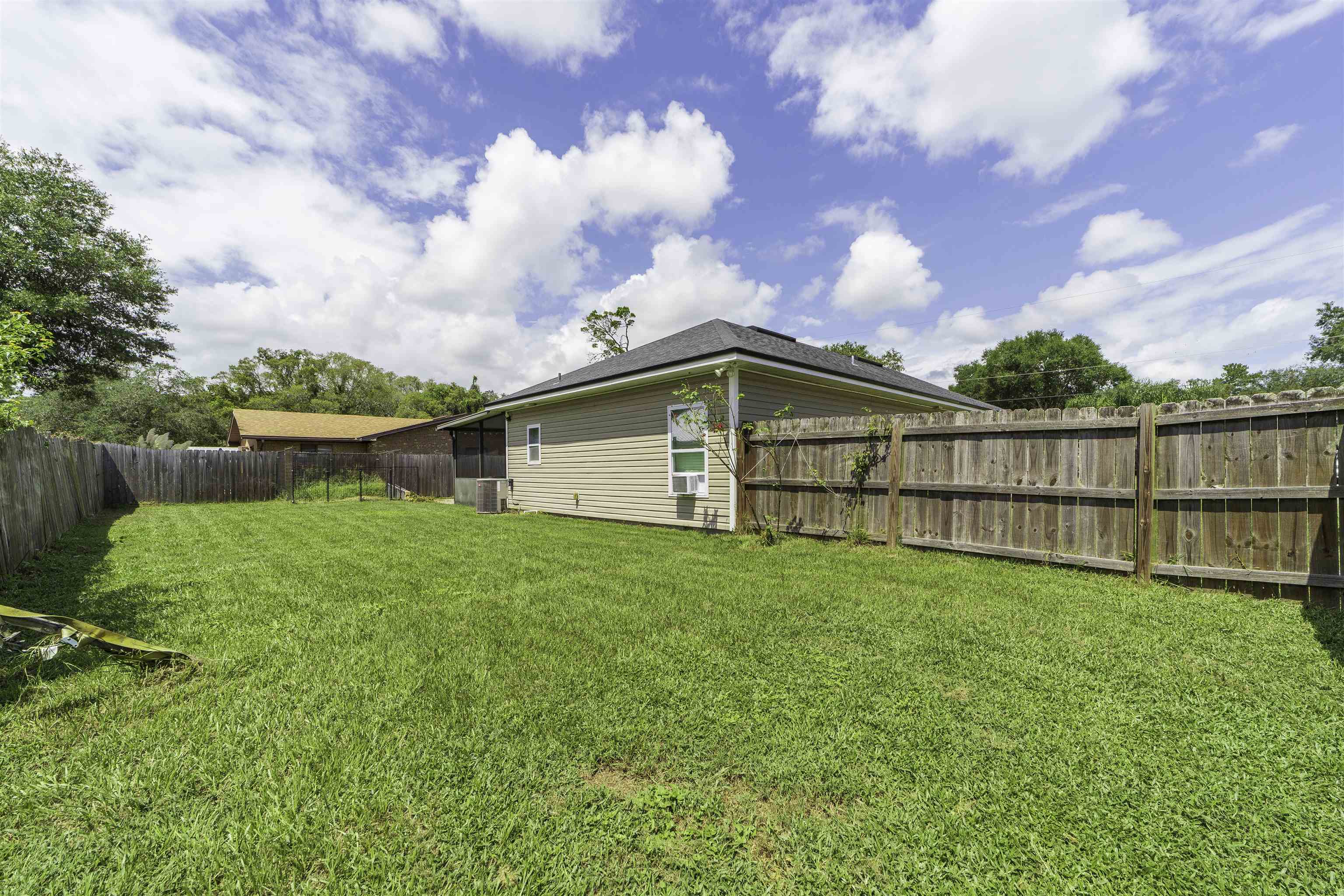 122 Osprey Road St. Augustine, FL 32086 - Photo 45 of 50 a view of a backyard with grass and a fence
