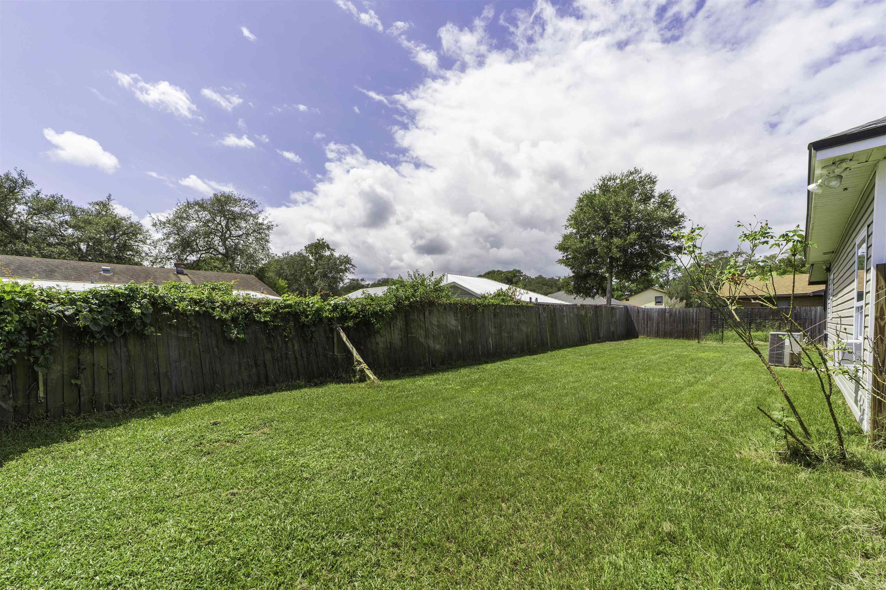 122 Osprey Road St. Augustine, FL 32086 - Photo 46 of 50 a backyard of a house with lots of green space and lake view