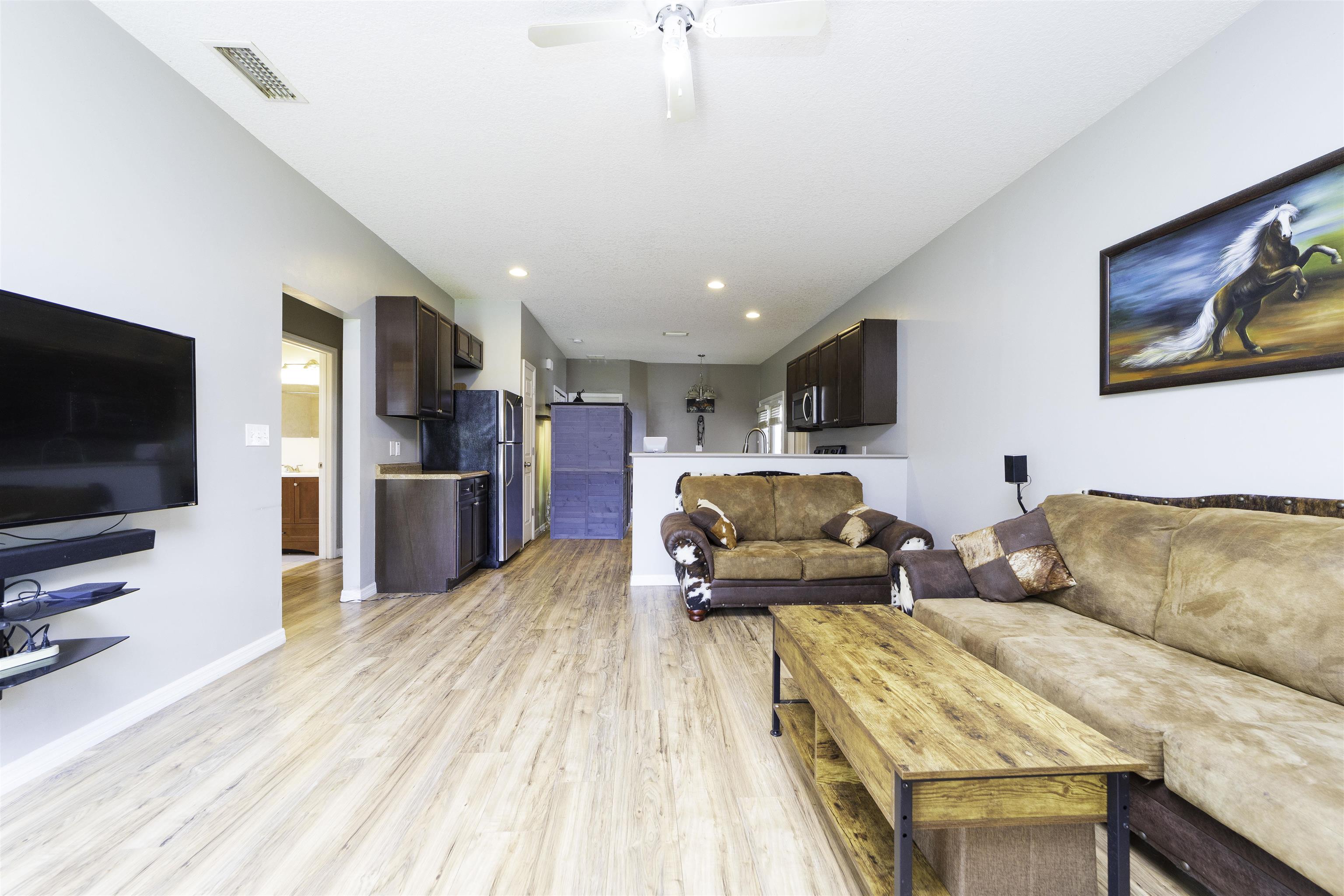 122 Osprey Road St. Augustine, FL 32086 - Photo 7 of 50 a living room with furniture and a flat screen tv