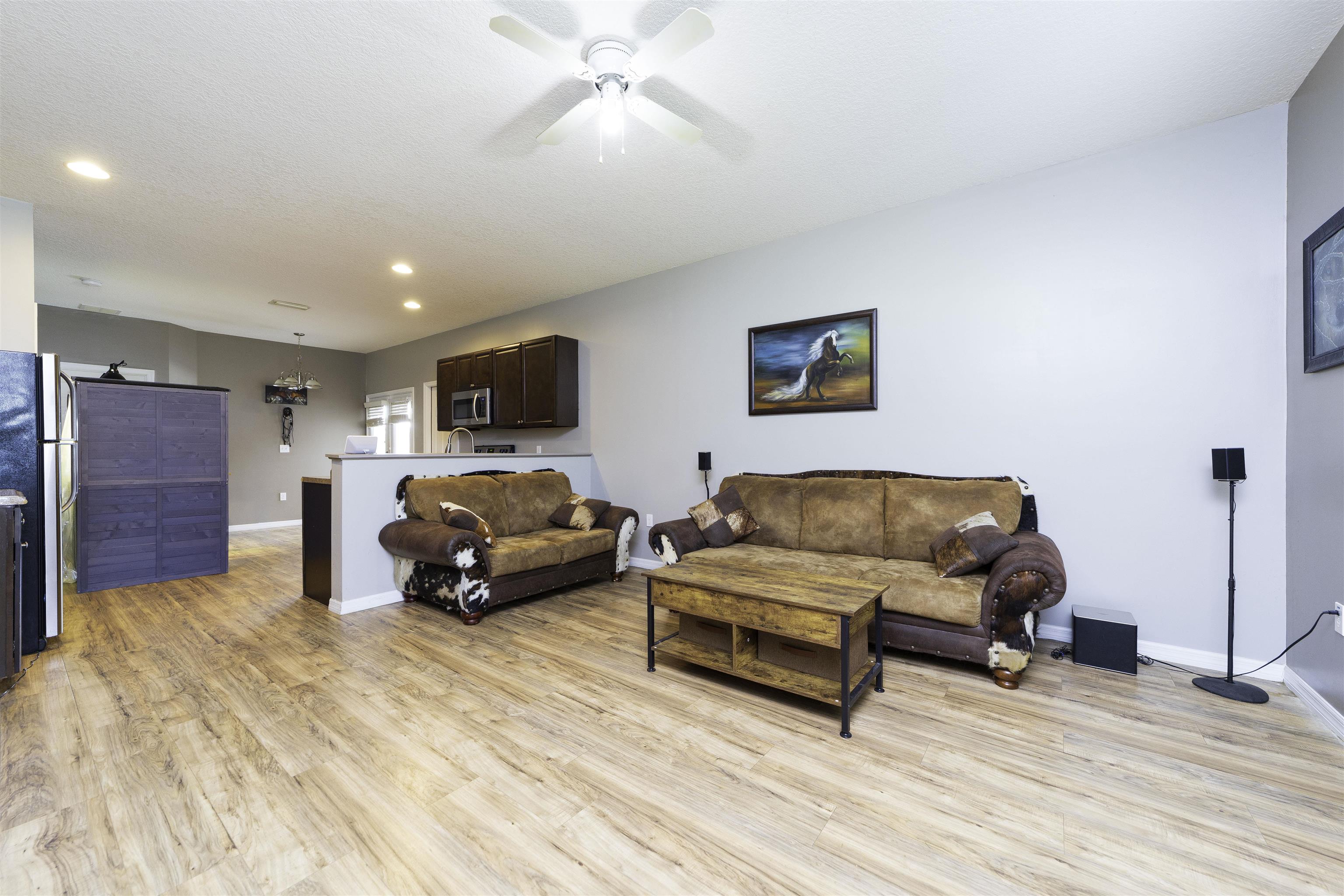 122 Osprey Road St. Augustine, FL 32086 - Photo 9 of 50 a living room with furniture and a wooden floor