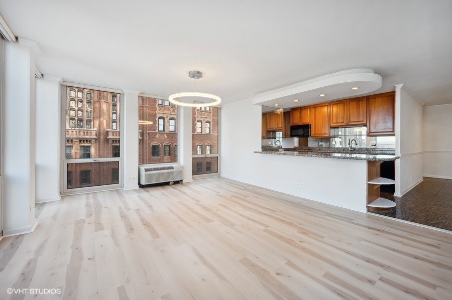 111 East Chestnut Street, Unit 14K Chicago, IL 60611 - Photo 6 of 20 a view of a kitchen with furniture and wooden floor