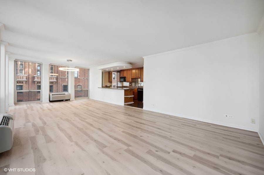 111 East Chestnut Street, Unit 14K Chicago, IL 60611 - Photo 7 of 20 a view of a living room with furniture and wooden floor