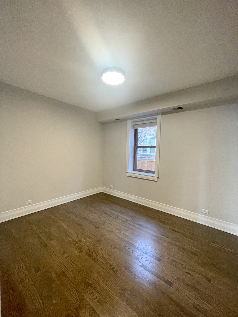 2539 West Iowa Street, Unit 3 Chicago, IL 60622 - Photo 13 of 19 a view of an empty room with wooden floor and a window