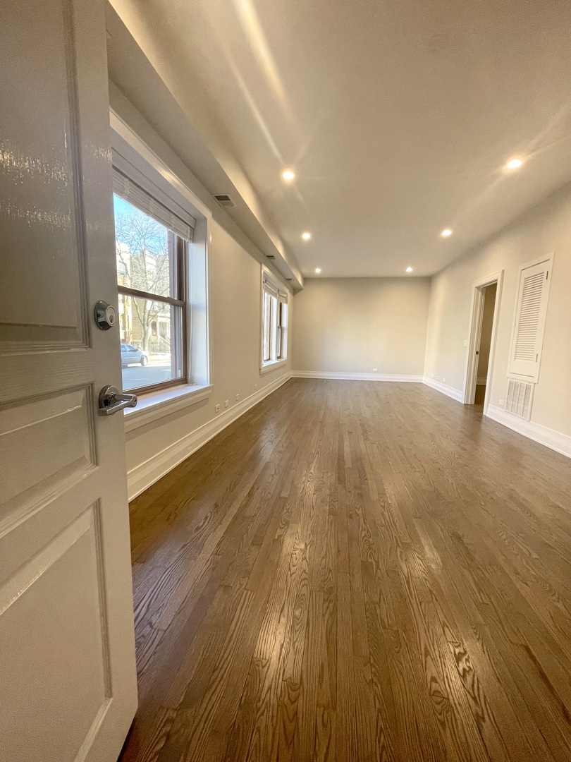 2539 West Iowa Street, Unit 3 Chicago, IL 60622 - Photo 2 of 19 a view of an empty room with wooden floor and a window