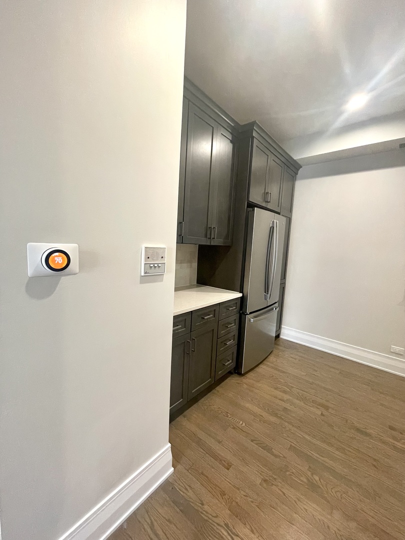 2539 West Iowa Street, Unit 3 Chicago, IL 60622 - Photo 5 of 19 a view of a refrigerator in kitchen and wooden floor
