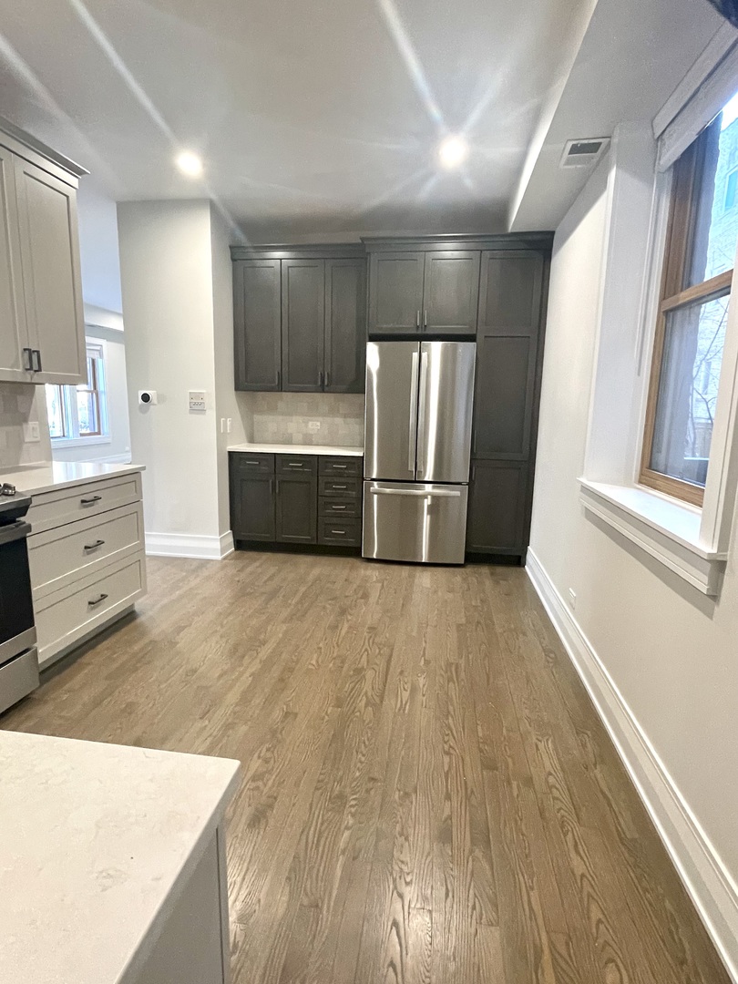 2539 West Iowa Street, Unit 3 Chicago, IL 60622 - Photo 9 of 19 a view of kitchen with refrigerator cabinets and wooden floor