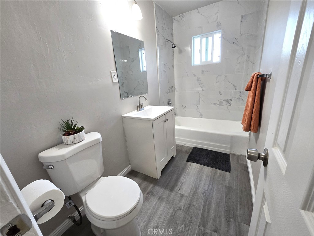 2140 Mahoney Drive Bakersfield, CA 93307 - Photo 13 of 16 a white toilet sitting next to a bathroom sink and tub