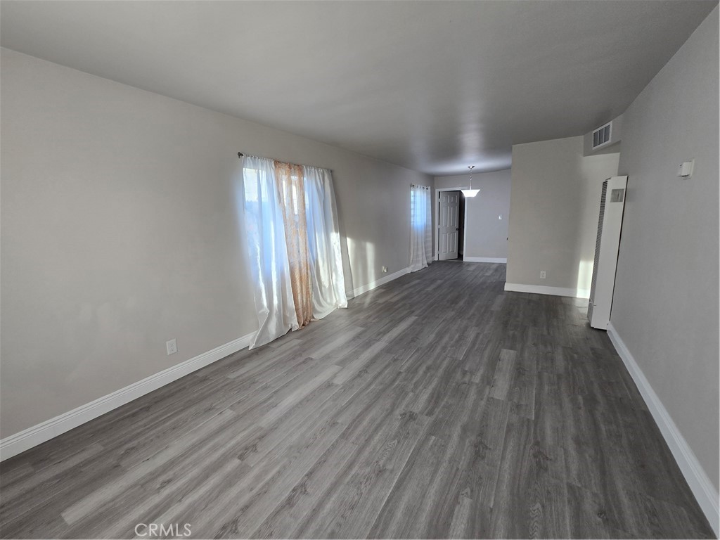 2140 Mahoney Drive Bakersfield, CA 93307 - Photo 16 of 16 wooden floor in an empty room with a window