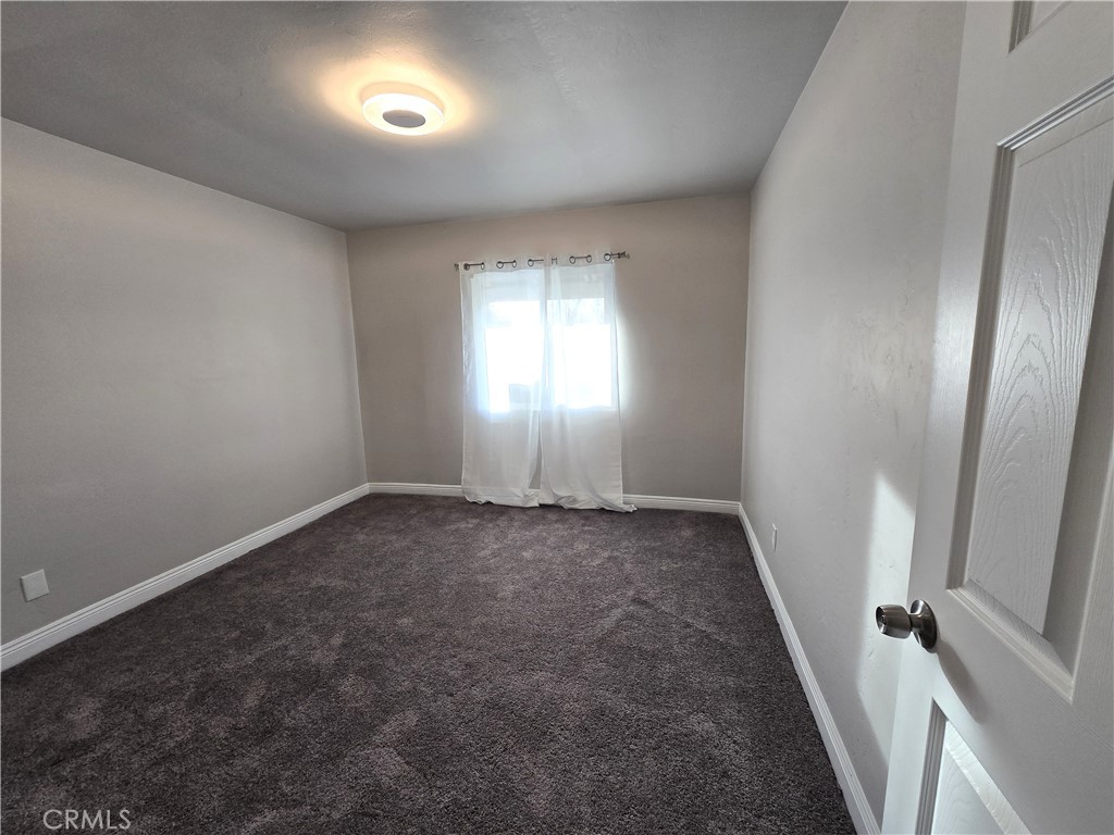2140 Mahoney Drive Bakersfield, CA 93307 - Photo 6 of 16 an empty room with windows and closet