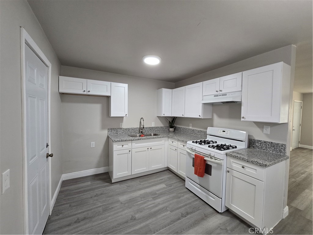 2140 Mahoney Drive Bakersfield, CA 93307 - Photo 10 of 16 a kitchen with a stove a sink and a refrigerator