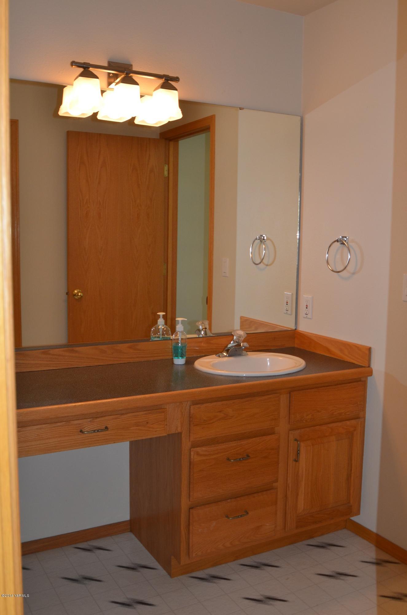 5405 Postma Road Yakima, WA 98901 - Photo 15 of 31 a bathroom with a sink and a mirror