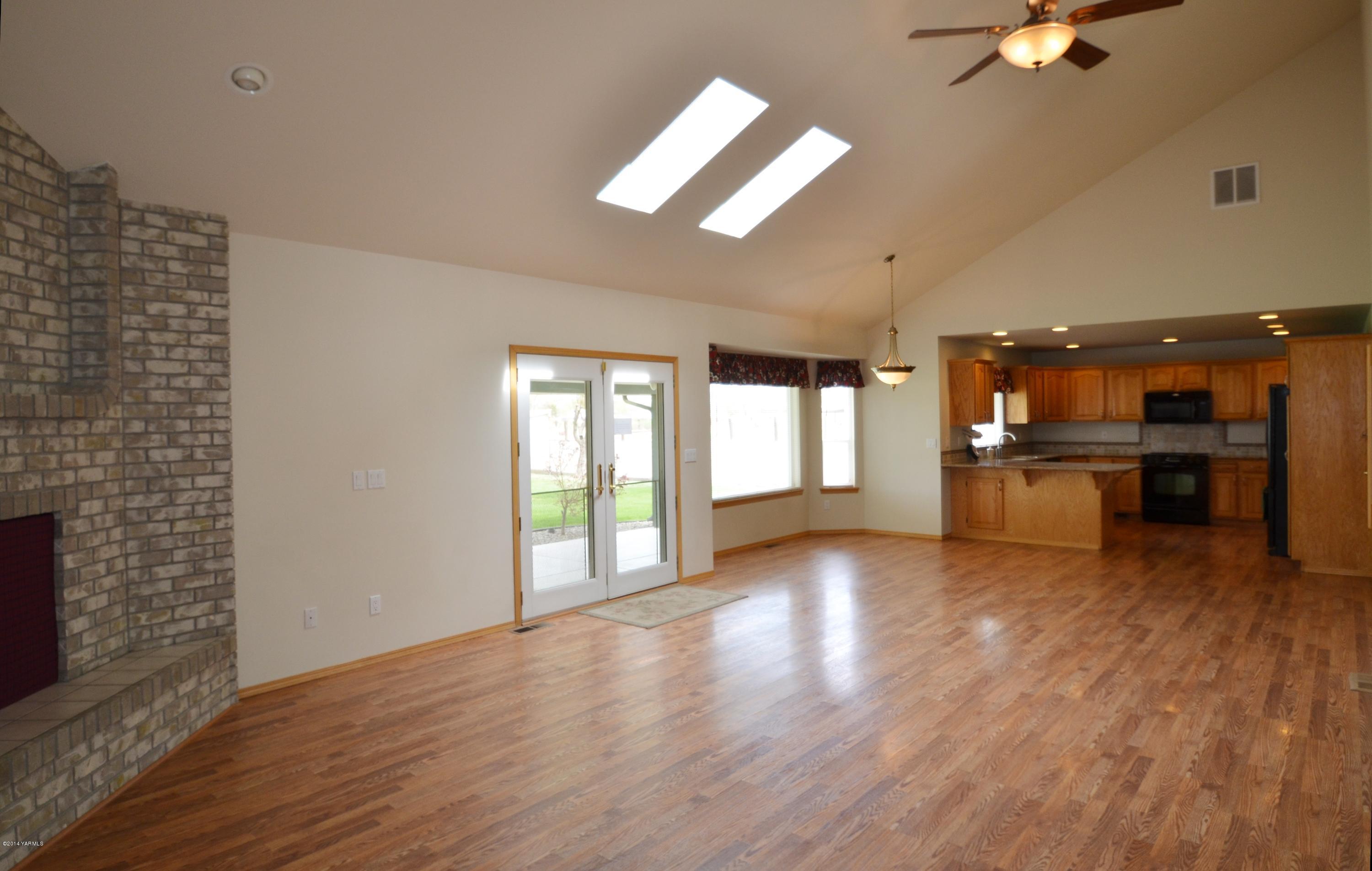 5405 Postma Road Yakima, WA 98901 - Photo 6 of 31 a view of an empty room with a window and wooden floor