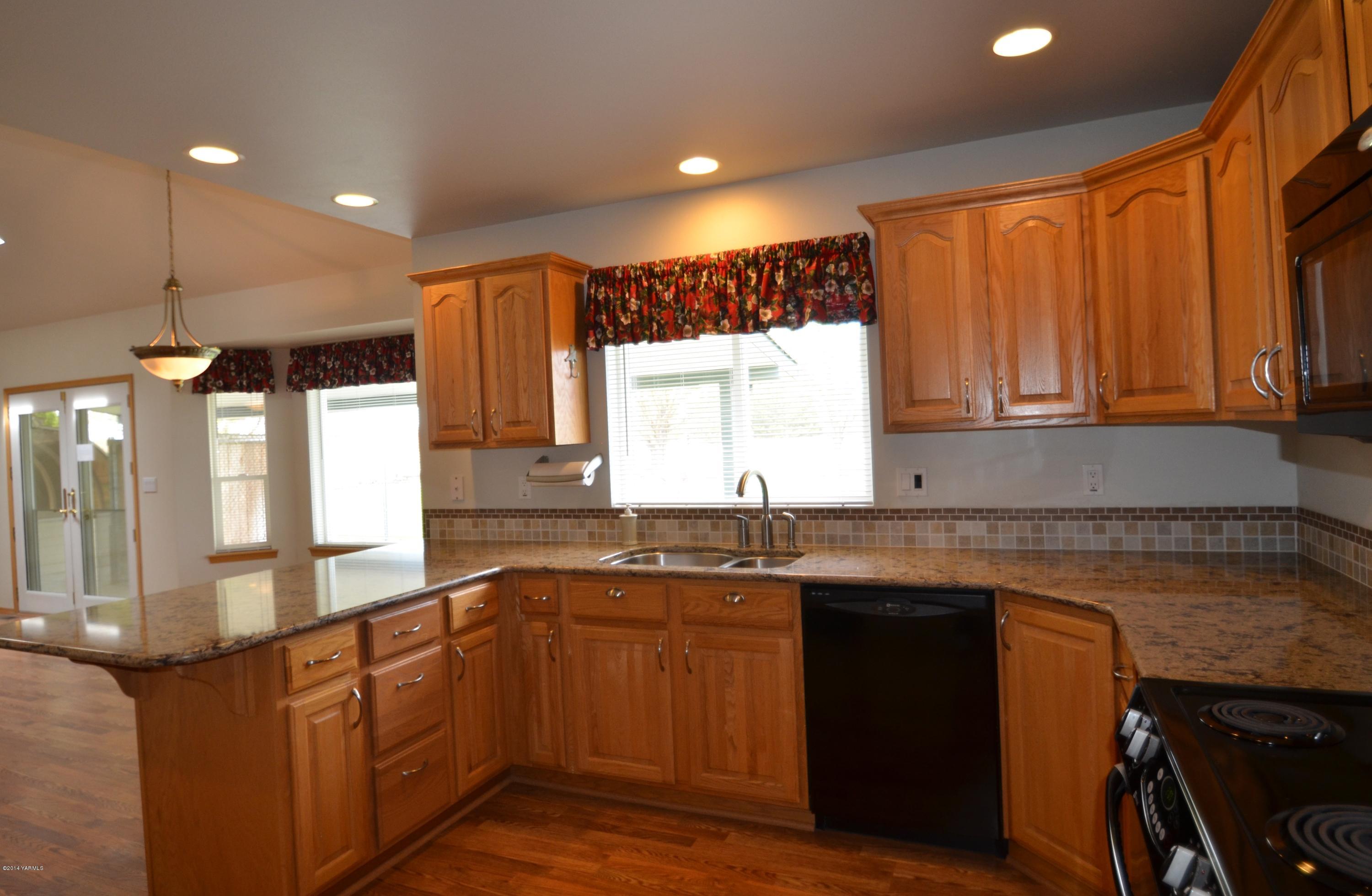 5405 Postma Road Yakima, WA 98901 - Photo 9 of 31 a kitchen with a sink stove and cabinets