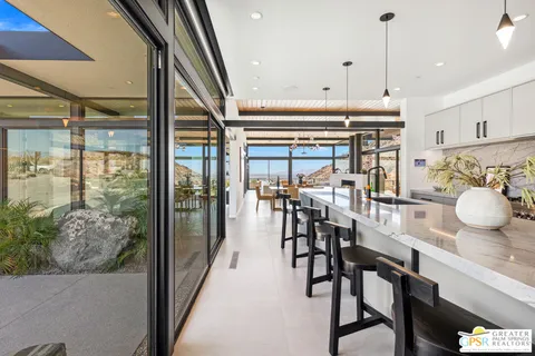 a bedroom with a large bed and a balcony view