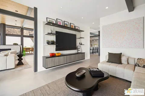 a living room with furniture and a floor to ceiling window
