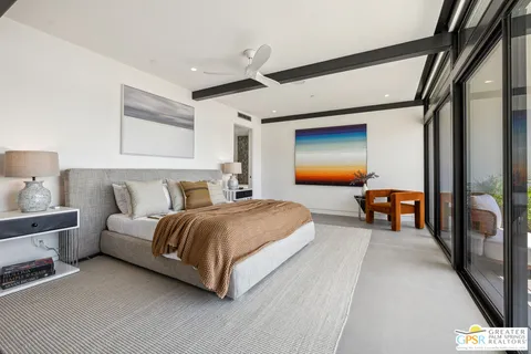 a bed room with a bed and a large window