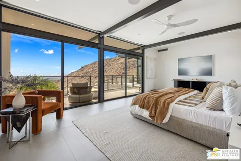 a spacious bedroom with a large bed and a large window