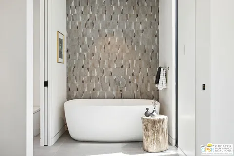 a living room with stainless steel appliances kitchen island granite countertop furniture and a fireplace