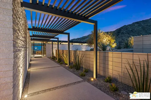 a living room with fireplace furniture and a large window